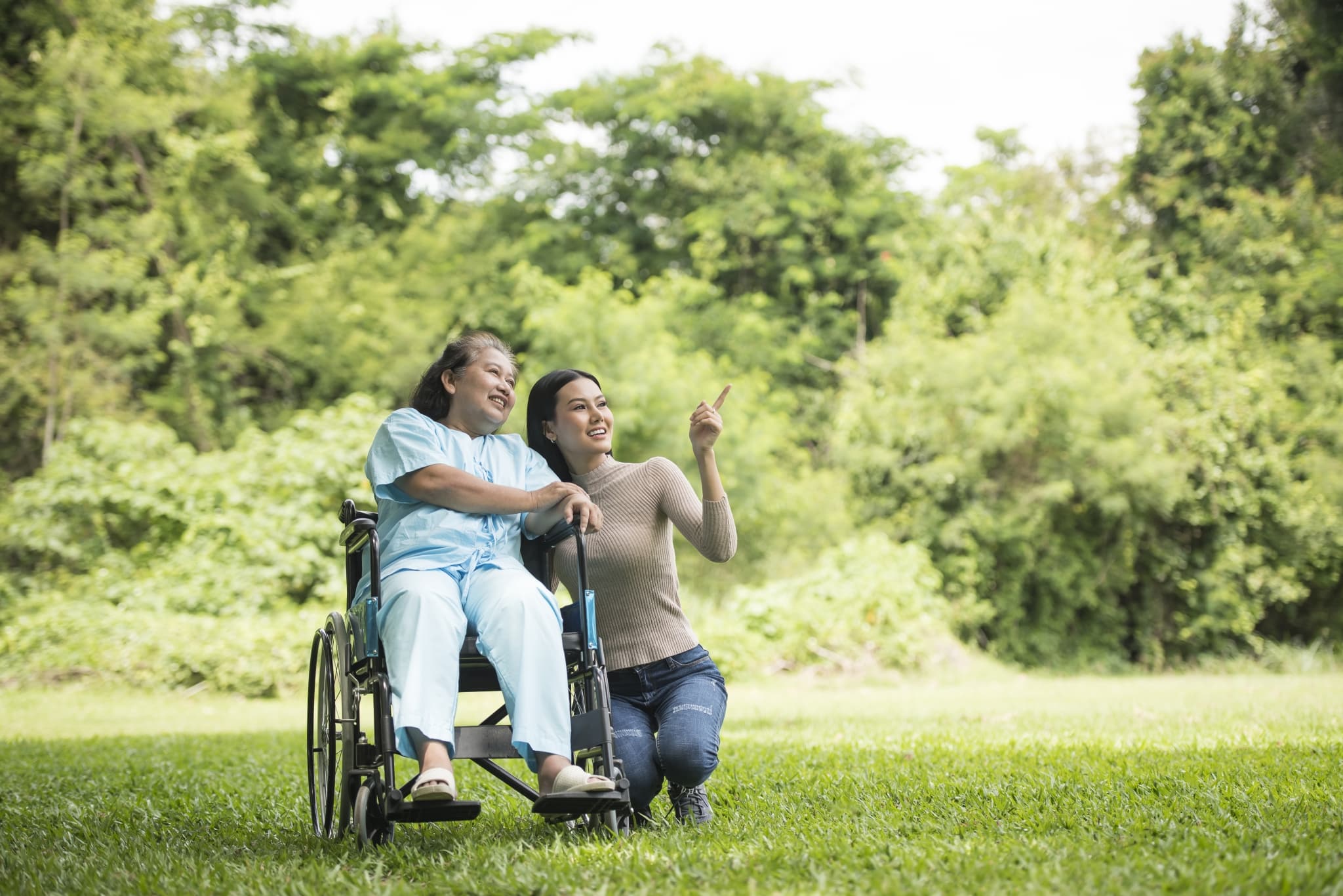 Granddaughter talking with her grandmother sitting on wheelchair