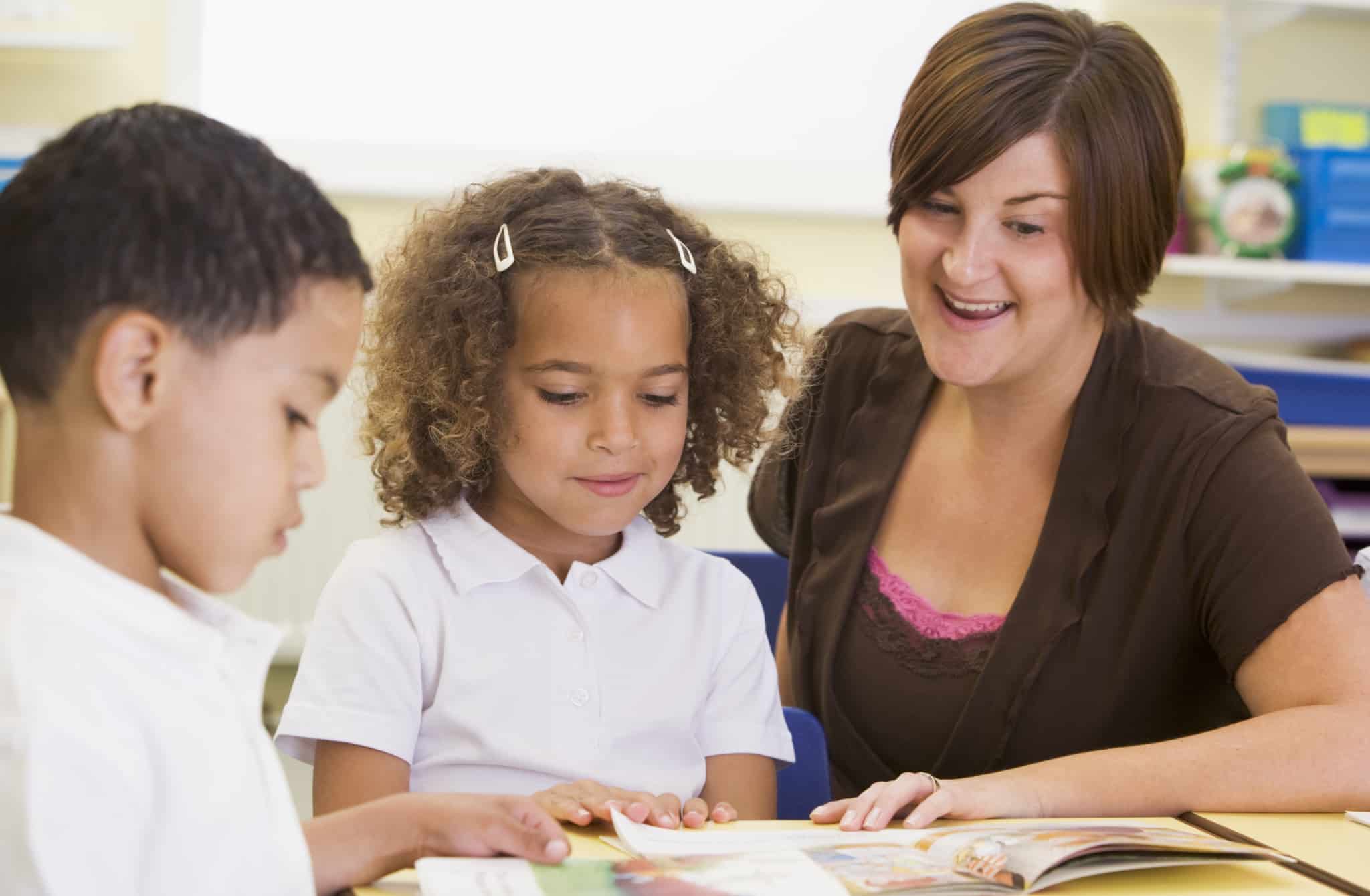 Teacher Helping Children To Read